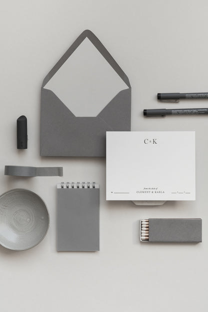 Minimalist personalized stationery set with grey envelope, card, notebook, pen and desk accessories