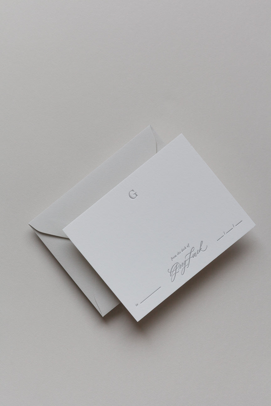 Personalized stationery card with embossed initial and envelope in neutral minimalist style