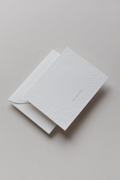 Embossed floral card with gold foil name shown with envelope backing