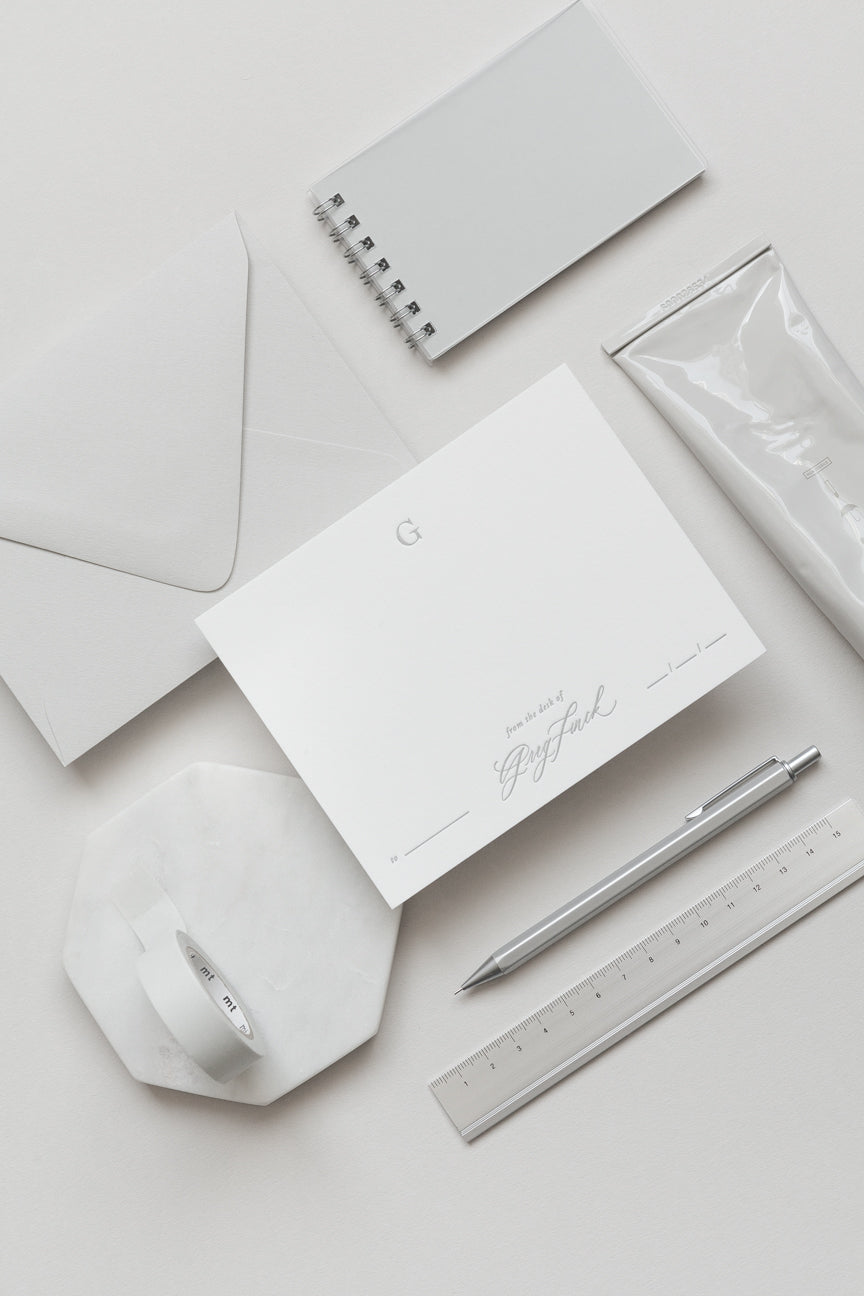 Minimal personalized stationery with envelope, card, pen and ruler in soft neutral tones