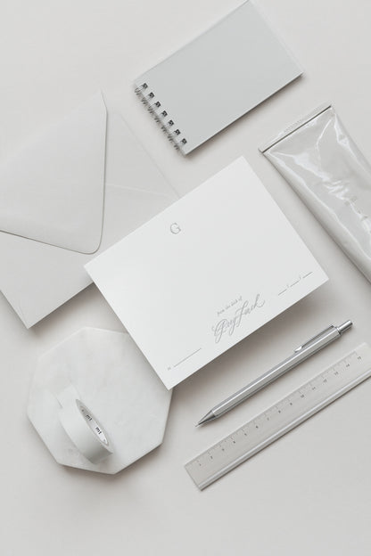Minimal personalized stationery with envelope, card, pen and ruler in soft neutral tones
