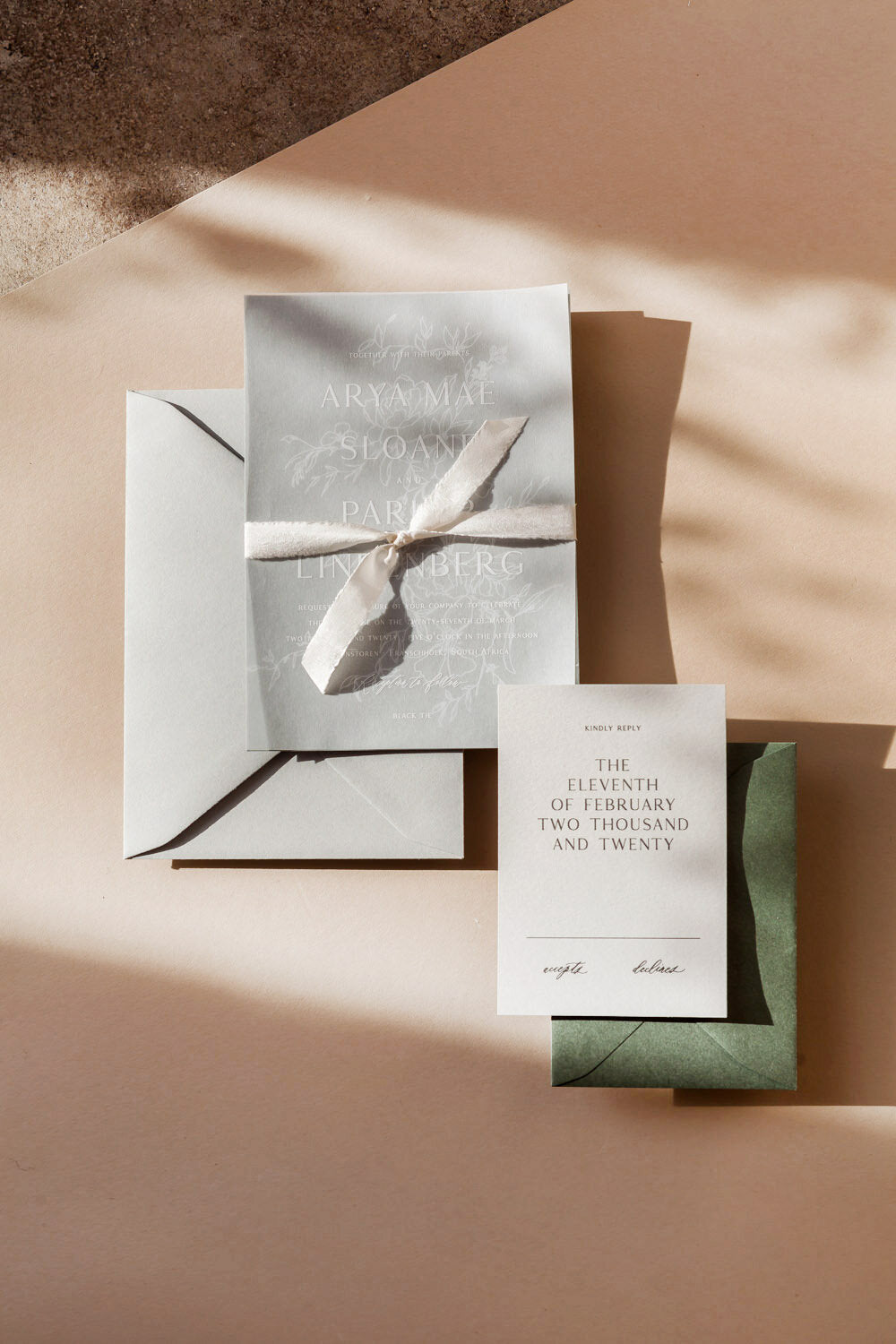 Minimalist wedding invitation suite with vellum overlay, ribbon wrap, RSVP card and neutral stationery design