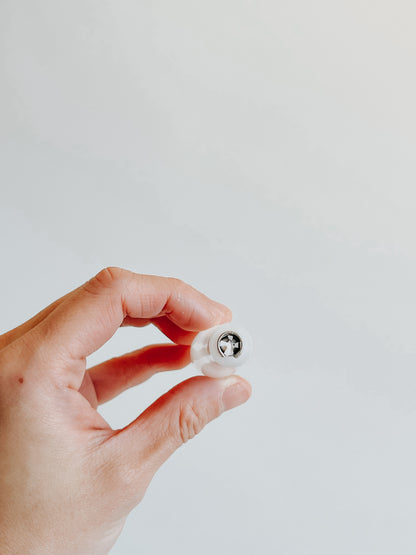 Close-up of the brass flange fitting inside a white straight pen holder, designed for curved pointed pen nibs